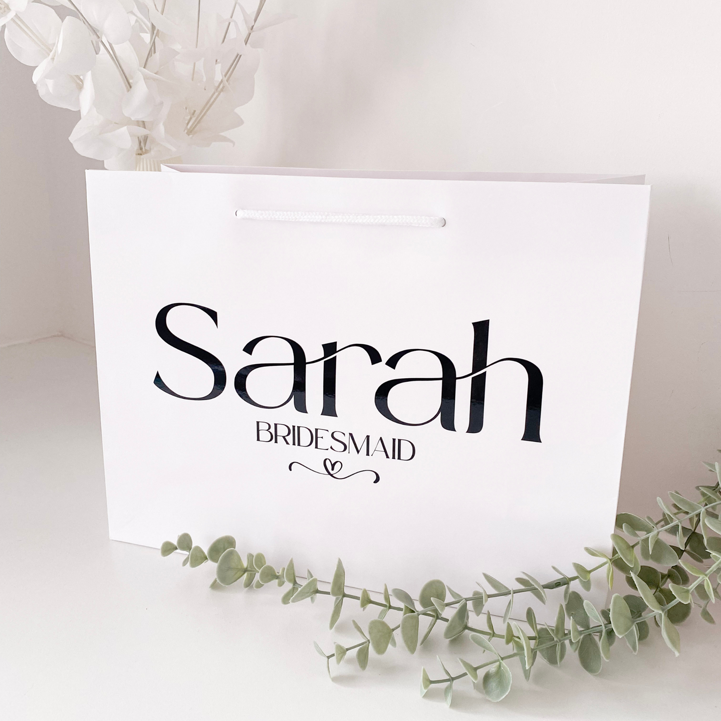 white gift bag personalised with a name. 
