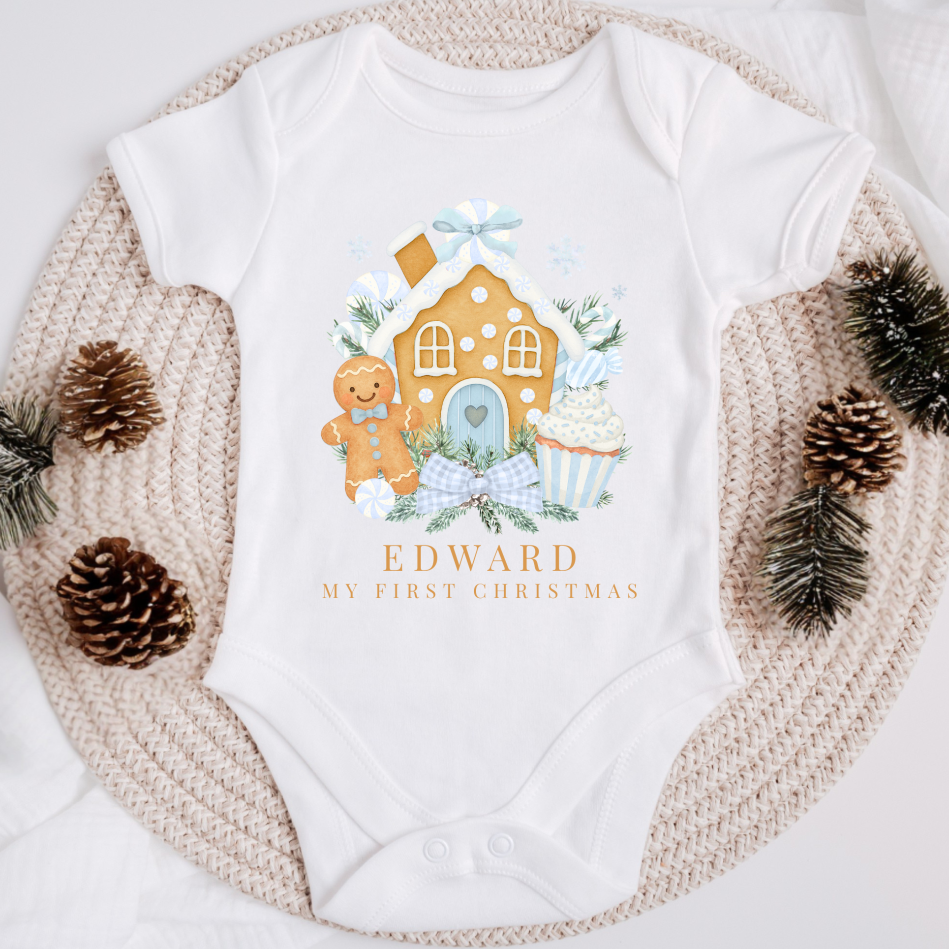 Baby onesie with Christmas-themed design and 'Edward My First Christmas' text, surrounded by decorative elements.