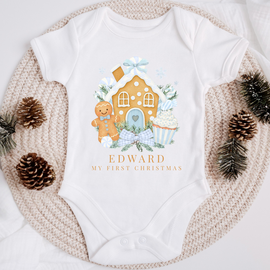 Baby onesie with Christmas-themed design and 'Edward My First Christmas' text, surrounded by decorative elements.