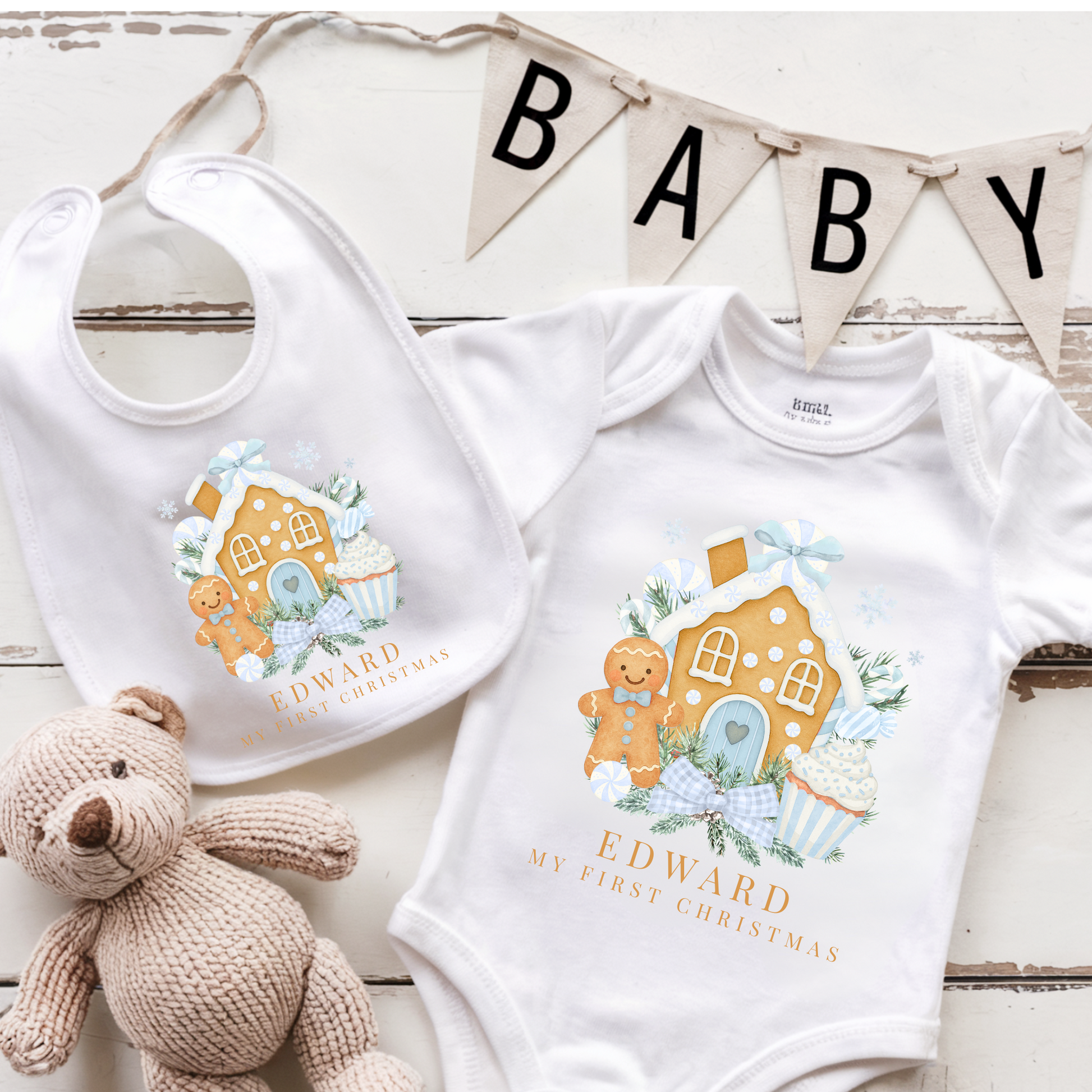 Baby bib and onesie with gingerbread design and 'My First Christmas' text, accompanied by a teddy bear and 'BABY' banner.