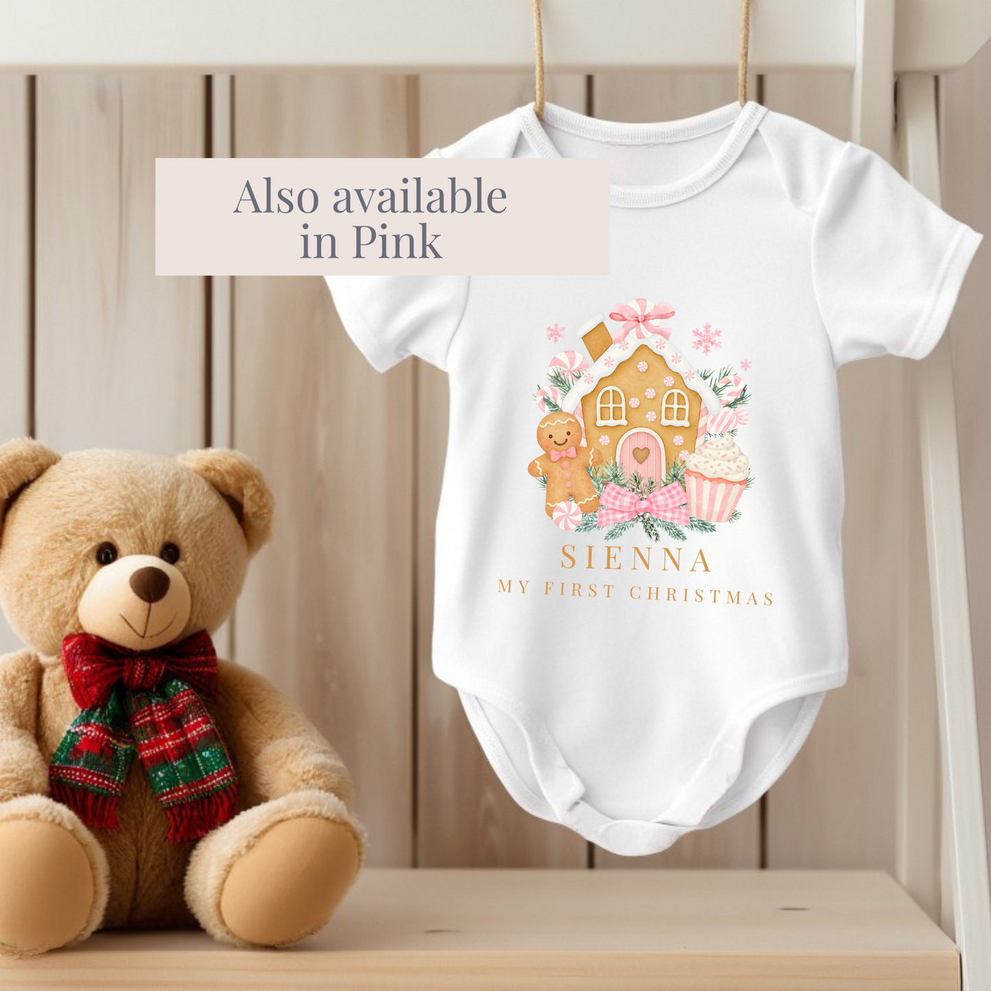 personalised Baby grow with gingerbread design and teddy bear next to it on a wooden surface