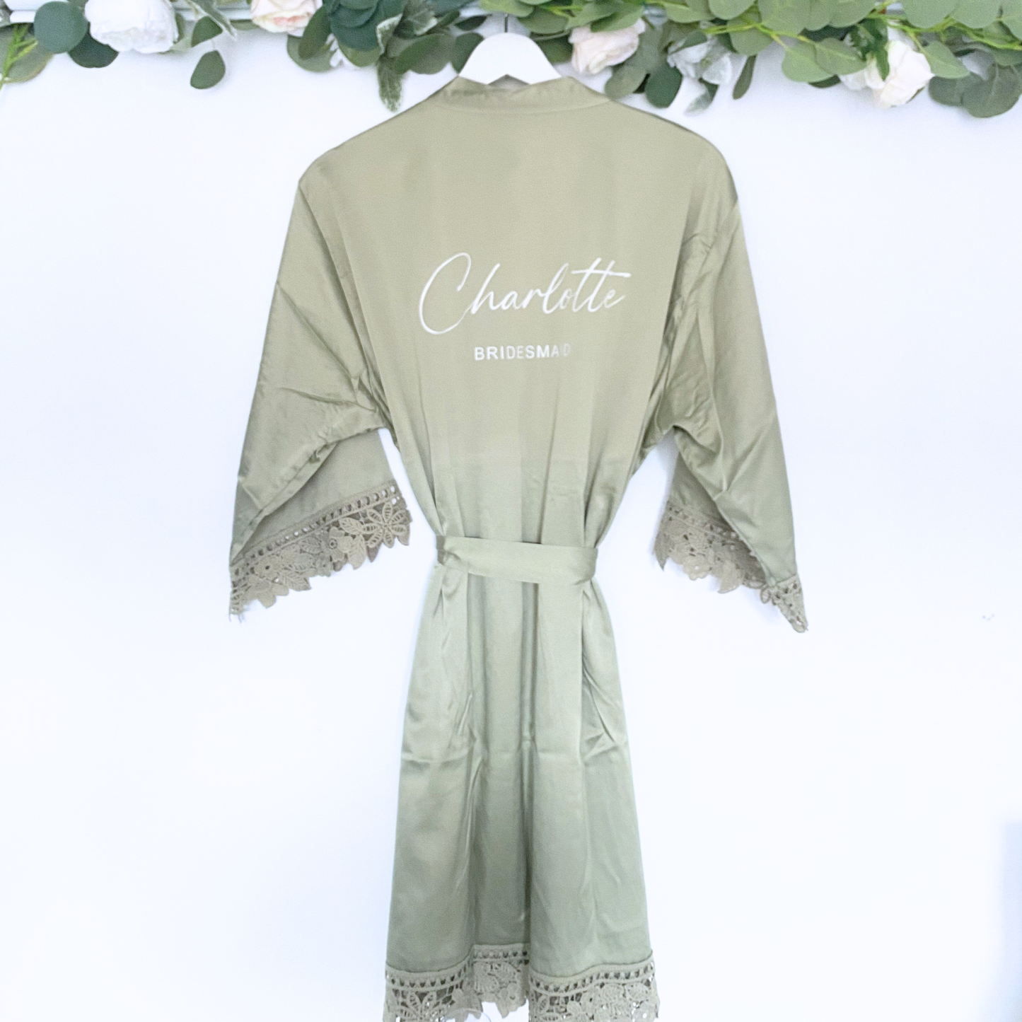 Sage satin bridesmaid robe with personalised name hanging on hanger