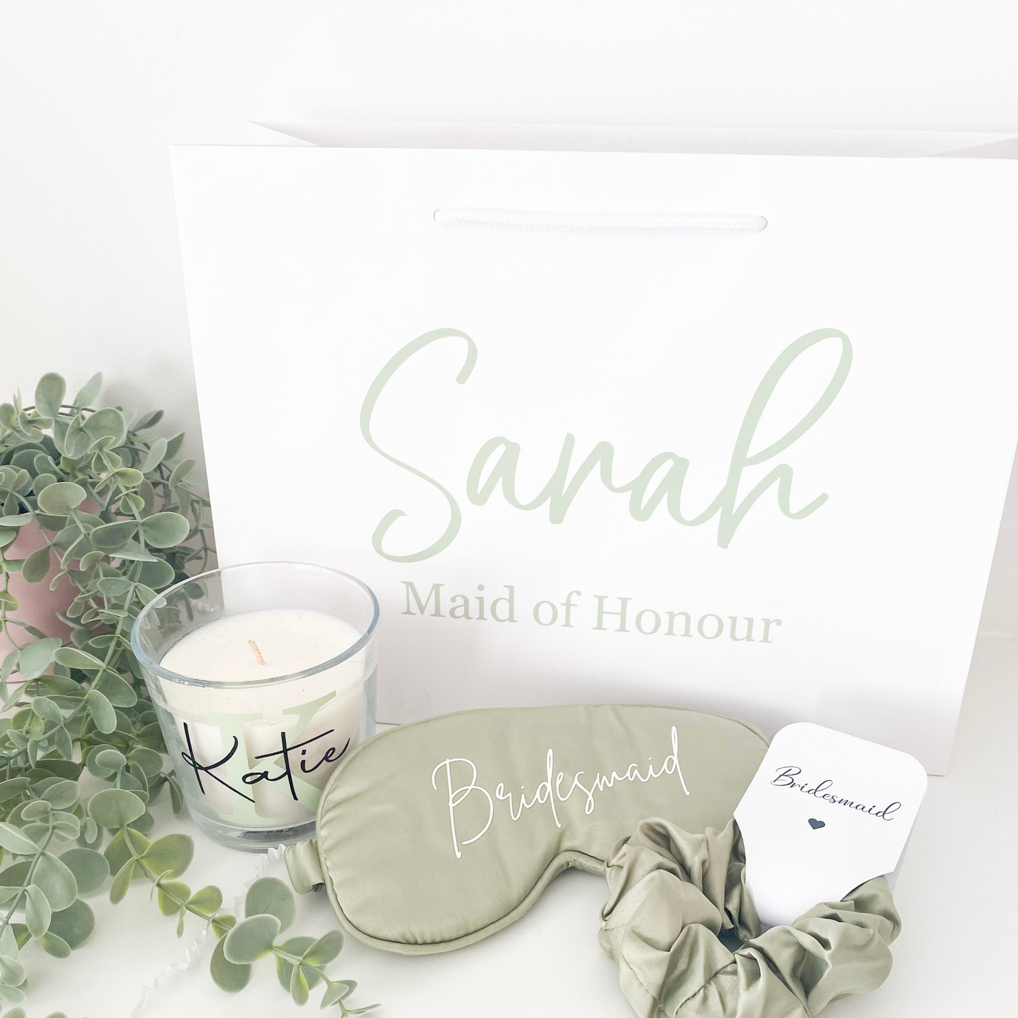 Sage green personalised bridal party gift bag with bridesmaid gifts inside, styled for a UK wedding in 2025 with a botanical colour theme.